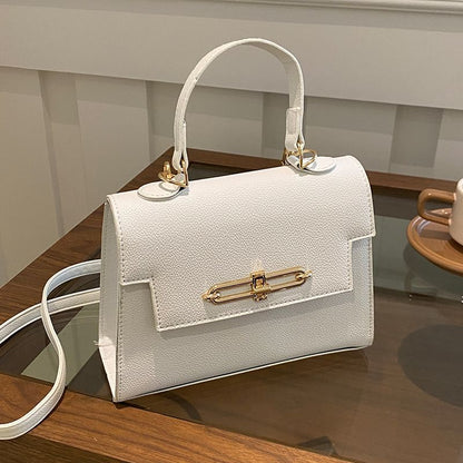  Shop white handbag with a top handle and gold clasp for women online 